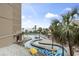 Aerial view of an outdoor pool area with lazy river, lounge chairs, and lush landscaping at 201 74Th Ave. N # 2243/2244, Myrtle Beach, SC 29572