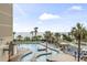 Lazy river and pool with plenty of lounge chairs, palm trees, and ocean view at 201 74Th Ave. N # 2243/2244, Myrtle Beach, SC 29572