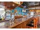 Charming bar with a wooden bar, stools, mirror, and television at 201 N 74Th Ave. N # 2249/2250, Myrtle Beach, SC 29572