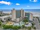 Hotel exterior and grounds feature an ocean view, pool, water slides, landscaping, and parking at 201 N 74Th Ave. N # 2249/2250, Myrtle Beach, SC 29572