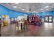 Bright game room with multiple arcade machines, tables, and chairs for relaxing at 201 N 74Th Ave. N # 2249/2250, Myrtle Beach, SC 29572