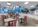 Open restaurant with large windows, tables and chairs, and an expansive menu board at 201 N 74Th Ave. N # 2249/2250, Myrtle Beach, SC 29572