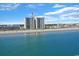 Aerial view of the building with the beach and ocean behind it at 201 S Ocean Blvd. # 1106, North Myrtle Beach, SC 29582