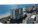Aerial view of the building with the beach and ocean behind it at 201 S Ocean Blvd. # 1106, North Myrtle Beach, SC 29582