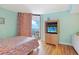 Bright bedroom with balcony, tv, and colorful bedspread at 201 S Ocean Blvd. # 1106, North Myrtle Beach, SC 29582