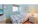 This cozy bedroom has matching decor, a beach-themed quilt, and luxury vinyl plank flooring at 201 S Ocean Blvd. # 1106, North Myrtle Beach, SC 29582