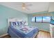 Nautical-themed bedroom with ocean view, ceiling fan, and cozy decor at 201 S Ocean Blvd. # 1106, North Myrtle Beach, SC 29582