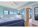 Bright bedroom with ceiling fan and access to balcony with ocean view at 201 S Ocean Blvd. # 1106, North Myrtle Beach, SC 29582