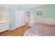 Cozy bedroom features a wicker bed frame, matching nightstand, and light aqua colored walls at 201 S Ocean Blvd. # 1106, North Myrtle Beach, SC 29582