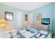 Comfortable bedroom with dresser, mirror, TV and light blue walls at 201 S Ocean Blvd. # 1106, North Myrtle Beach, SC 29582