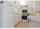 Bright kitchen features white appliances, ample cabinet space, and charming nautical accents above at 201 S Ocean Blvd. # 1106, North Myrtle Beach, SC 29582