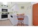 Cozy kitchen with white cabinets, tile floor, and barstool seating at 201 S Ocean Blvd. # 1106, North Myrtle Beach, SC 29582