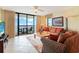 Comfortable living room with sliding glass door to balcony and ocean view at 201 S Ocean Blvd. # 1106, North Myrtle Beach, SC 29582
