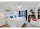 The bedroom features a plush white bed with blue pillows, a desk, and a window with views of the outside at 202 North Ocean Blvd. # 109, North Myrtle Beach, SC 29582