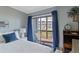 Comfortable bedroom with balcony access and calming decor for a relaxing stay at 202 North Ocean Blvd. # 109, North Myrtle Beach, SC 29582