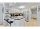 Stylish kitchen with a breakfast bar featuring granite countertops and white cabinetry at 202 North Ocean Blvd. # 109, North Myrtle Beach, SC 29582