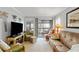 The living room has comfortable furnishings, a large flat-screen TV, and access to the screened porch with outdoor views at 202 North Ocean Blvd. # 109, North Myrtle Beach, SC 29582