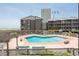Unit 109 overlooking the sparkling community pool surrounded by lush landscaping at 202 North Ocean Blvd. # 109, North Myrtle Beach, SC 29582