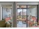 Relax on this unit's screen porch with comfortable seating overlooking lush landscaping and the ocean in the distance at 202 North Ocean Blvd. # 109, North Myrtle Beach, SC 29582