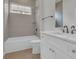 Well-lit bathroom features a shower-tub combo, white cabinets, and bronze fixtures at 214 Olde Harbour Ct, Little River, SC 29566