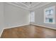 This bedroom has natural light, hardwood floors, neutral walls, and modern finishes at 214 Olde Harbour Ct, Little River, SC 29566