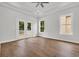 Bright bedroom with hardwood floors, French doors, tray ceilings, and natural light at 214 Olde Harbour Ct, Little River, SC 29566