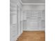 Spacious walk-in closet features custom built-in shelving, drawers, and ample hanging space at 214 Olde Harbour Ct, Little River, SC 29566