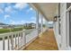 A spacious deck offers views of the serene water and inviting neighborhood, perfect for relaxing or entertaining guests at 214 Olde Harbour Ct, Little River, SC 29566