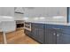 Close up of a modern kitchen features white cabinets, stainless steel appliances, and a stylish blue island at 214 Olde Harbour Ct, Little River, SC 29566