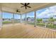 Open-air porch overlooking waterway and houses with white railings and natural wood floors at 214 Olde Harbour Ct, Little River, SC 29566