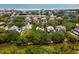 Picturesque aerial view of homes nestled among lush trees, waterways, and a distant ocean view at 214 Sea Island Dr., Georgetown, SC 29440