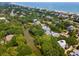 Serene aerial view highlighting waterfront homes among trees, canals, and a tranquil beach at 214 Sea Island Dr., Georgetown, SC 29440