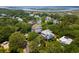 Aerial shot shows houses with trees and landscaping alongside a waterway, with marshland in background at 214 Sea Island Dr., Georgetown, SC 29440