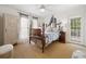 Charming bedroom with four-poster bed, ceiling fan, and a door to the outside at 214 Sea Island Dr., Georgetown, SC 29440