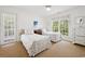 Bright bedroom with two twin beds, a ceiling fan, and plenty of natural light at 214 Sea Island Dr., Georgetown, SC 29440
