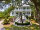 Charming two-story home with white siding, multiple porches, and a circular driveway at 214 Sea Island Dr., Georgetown, SC 29440
