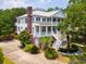 Elegant white two-story home featuring a large porch, brick chimney, and landscaped yard at 214 Sea Island Dr., Georgetown, SC 29440