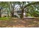 Exterior showcasing multi-level porch areas with beautiful landscaping, surrounded by mature trees at 214 Sea Island Dr., Georgetown, SC 29440