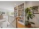 Bright hallway features custom built-in bookshelves and traditional banister with natural light at 214 Sea Island Dr., Georgetown, SC 29440