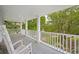 Relaxing outdoor porch with traditional rocking chairs overlooking beautifully landscaped backyard at 214 Sea Island Dr., Georgetown, SC 29440