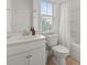 Bright bathroom with white vanity, toilet, mirror, and shower/tub combination at 223 Southgate Ct., Pawleys Island, SC 29585