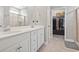 Bright bathroom featuring a dual sink vanity with white cabinets and a tiled shower behind glass at 223 Southgate Ct., Pawleys Island, SC 29585