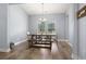 Bright dining room with a wooden table, bench seating, and modern chandelier at 223 Southgate Ct., Pawleys Island, SC 29585