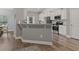 Modern kitchen with white cabinets, stainless steel appliances, and a breakfast bar at 223 Southgate Ct., Pawleys Island, SC 29585