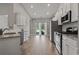 Open kitchen with granite countertops, stainless steel appliances, and access to the backyard at 223 Southgate Ct., Pawleys Island, SC 29585