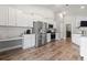 Well-lit kitchen with white cabinetry, stainless steel appliances, and a cozy breakfast nook at 223 Southgate Ct., Pawleys Island, SC 29585