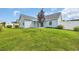 Well-maintained backyard with lush green lawn, covered patio, and mature landscaping at 252 Heath Dr., Longs, SC 29568