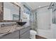 Stylish bathroom features a decorative mirror, vessel sink, and a shower with patterned curtain at 252 Heath Dr., Longs, SC 29568