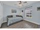 Cozy bedroom with a daybed, ceiling fan, neutral walls, and nautical-themed decor at 252 Heath Dr., Longs, SC 29568