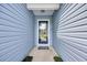 Covered entryway with a blue glass door and neutral-colored siding at 252 Heath Dr., Longs, SC 29568